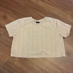 Air Jordan cropped t-shirt, with slit-open back. Size large. Tan color.
